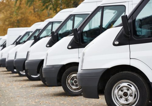 26773629 - commercial delivery vans in row at parking place of transporting carrier shipping service company